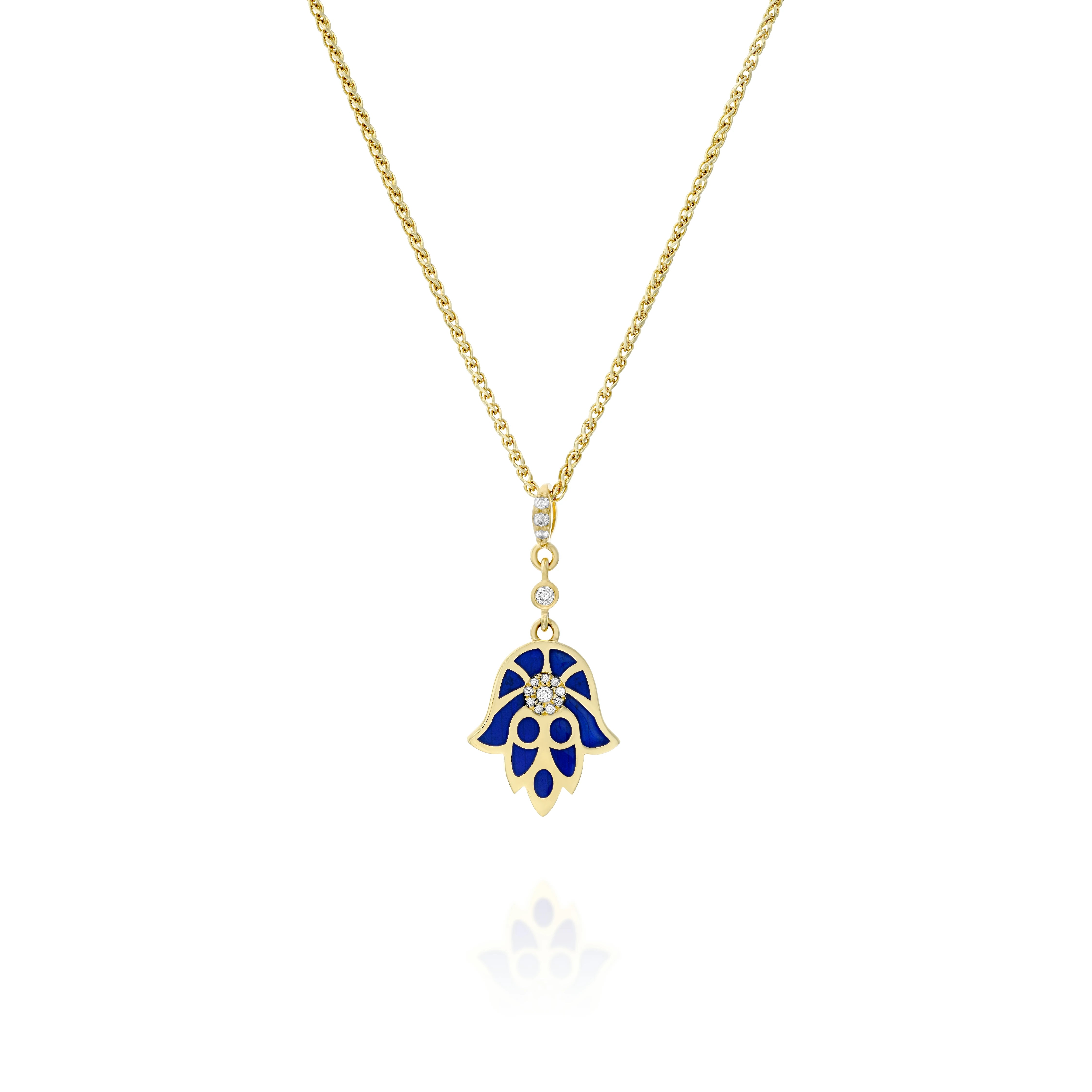 A Hamsa pendant crafted from gold, diamonds, and blue enamel . At its heart lies the guardian eye (against the evil eye) set with diamonds, that always carefully watches and protects us. The exact spectacle shade of our blue enamel represents the ancient hidden heart wisdom, its protective and unifying strength. This Hamsa features a unique design: A network of gold lines over the blue magnificent enamel. It combines an oriental aesthetic with contemporary touch.